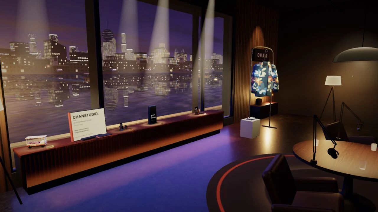 A working studio overlooking Dubai Creek at night: a ChanStudio folio, Stealth Labs and Forgeai on a walnut shelf, and a colourful Founder Threads jacket on a clothing rail. A small Milkfloat keepsake and Earworm phone sit among them.